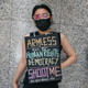 A protester lies on the floor of the arrival hall of Hong Kong International Airport during a demonstration on Aug. 12, 2019.